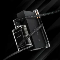 Luxury Alpha Male Arona fragrance set with glass perfume bottle, black gift box, and spray vial on a dark, dramatic background.