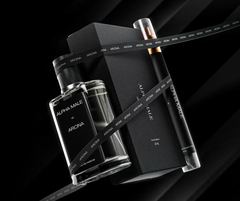 Luxury Alpha Male Arona fragrance set with glass perfume bottle, black gift box, and spray vial on a dark, dramatic background.
