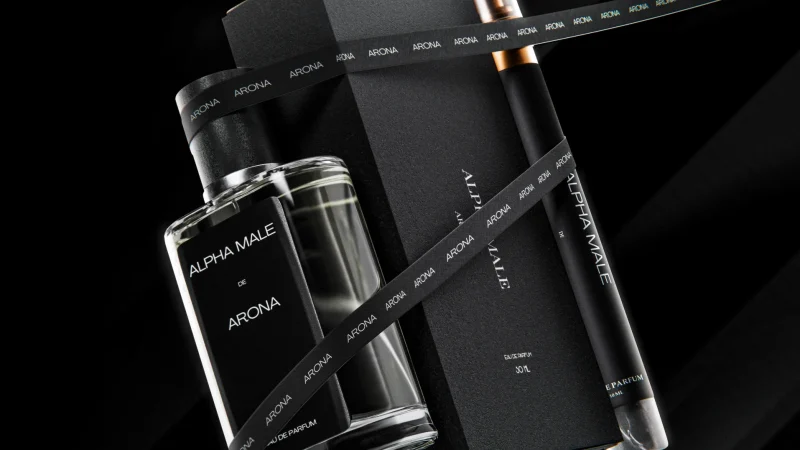 Luxury Alpha Male Arona fragrance set with glass perfume bottle, black gift box, and spray vial on a dark, dramatic background.
