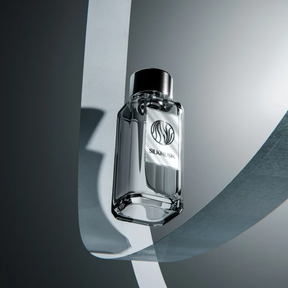 Reflective silver SILK... perfume bottle surrounded by flowing gray ribbons and dramatic shadows, creating a sleek, luxurious mood.