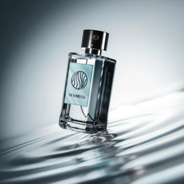Studio product photo of a clear Silk Musk perfume bottle with black cap, resting in rippling water and dramatic light; sleek, luxurious mood.