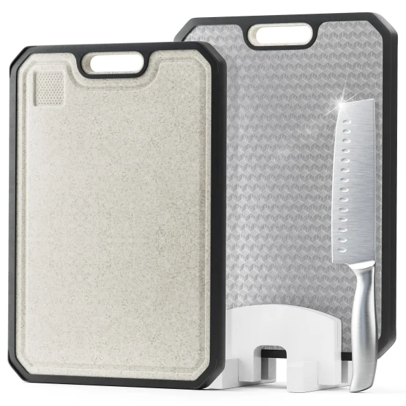 Two rectangular cutting boards, white and gray textured, stand upright with a chef’s knife and white holder, showcasing kitchen tools.