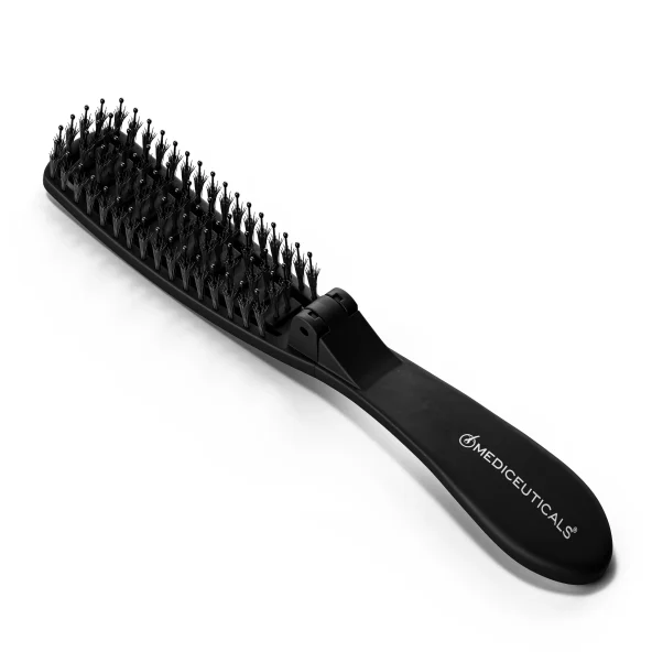Black Mediceuticals scalp massager brush with dense pointed bristles and curved handle, shown on a white background; sleek, clinical design.