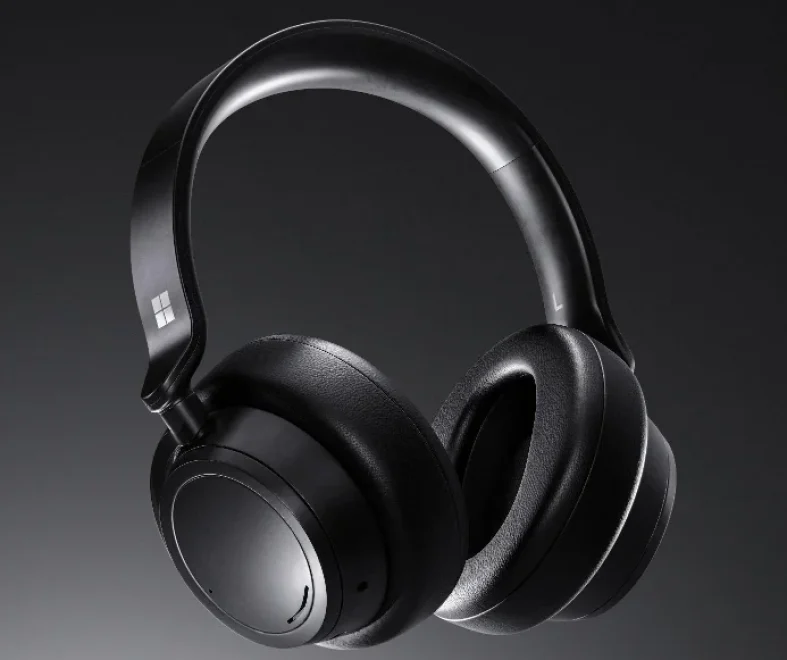 Black over-ear wireless headphones with padded ear cups and a sleek curved headband, photographed against a dark background for a premium, modern tone.